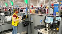 Walmart employee at self-checkout.