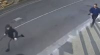 Security camera footage of a man chasing a person.