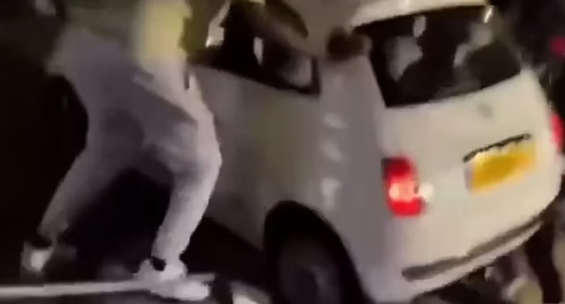 People lifting a car off a person.