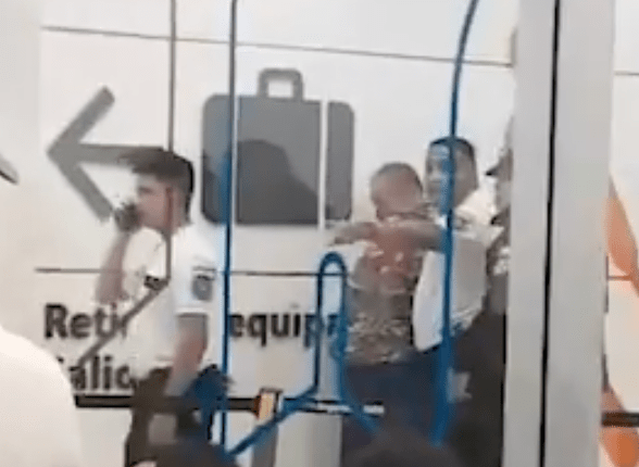 Security personnel detaining a person at an airport.
