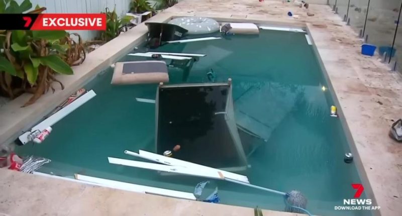 Swimming pool with furniture and trash in it after a party.