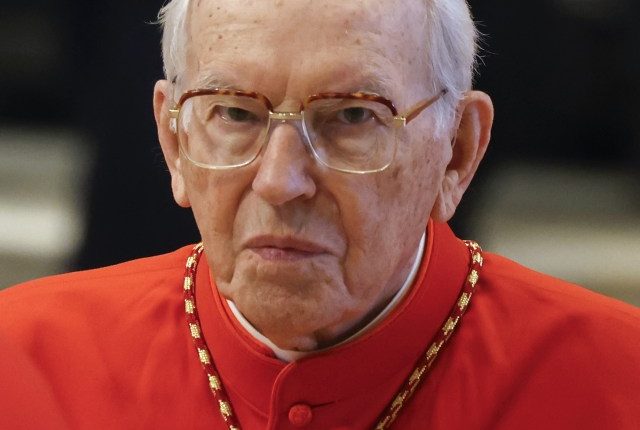 Cardinal Giovanni Battista Re paying respects to Pope Francis.