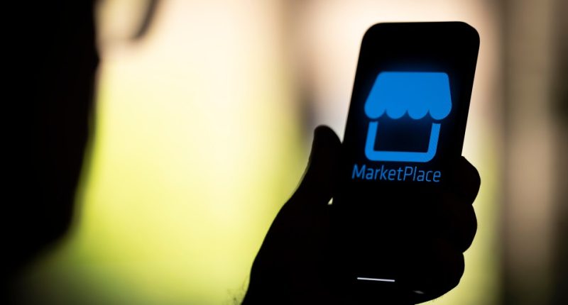 Photo illustration of a person holding a smartphone displaying the Facebook Marketplace logo.
