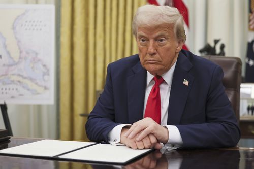 President Donald Trump listens to a question from a reporter before signing an executive order in the Oval Office of the White House in Washington, Monday, March 31, 2025. (Pool via AP)