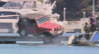 A dramatic standoff with police in Perth this afternoon ended with a man driving a Jeep off a jetty into the water.