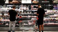 In this photo illustration, shoppers look at meat products on display at a inner-city grocery store on March 25, 2025 in Sydney, Australia.