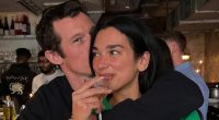 Dua Lipa shows off her dazzling engagement ring in loved-up snaps with fiancé Callum Turner as the singer returns home from tour