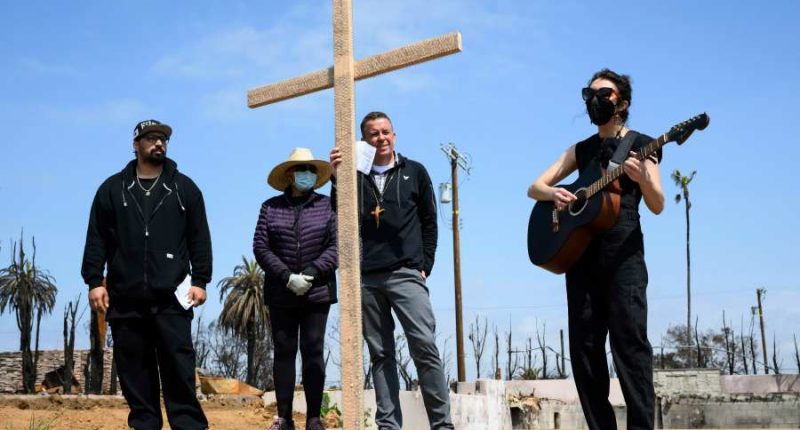 Members of burned LA church bear a cross through their devastated neighborhood to mark Good Friday