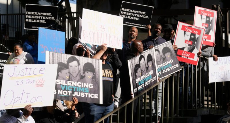 Supporters hold signs during a press conference regarding developments in the Menendez brothers case Thursday, March 20, 2025, in Los Angeles. (AP Photo/Damian Dovarganes)