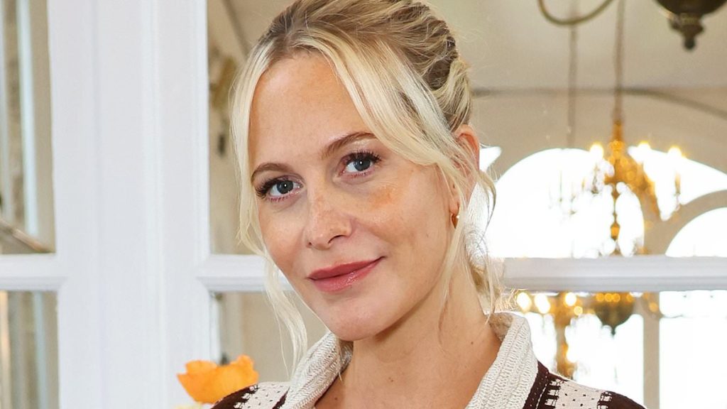 Pregnant Poppy Delevingne cradles her baby bump in a trendy striped shirt co-ord as she celebrates her new collaboration with Nobody's Child