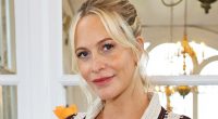 Pregnant Poppy Delevingne cradles her baby bump in a trendy striped shirt co-ord as she celebrates her new collaboration with Nobody's Child