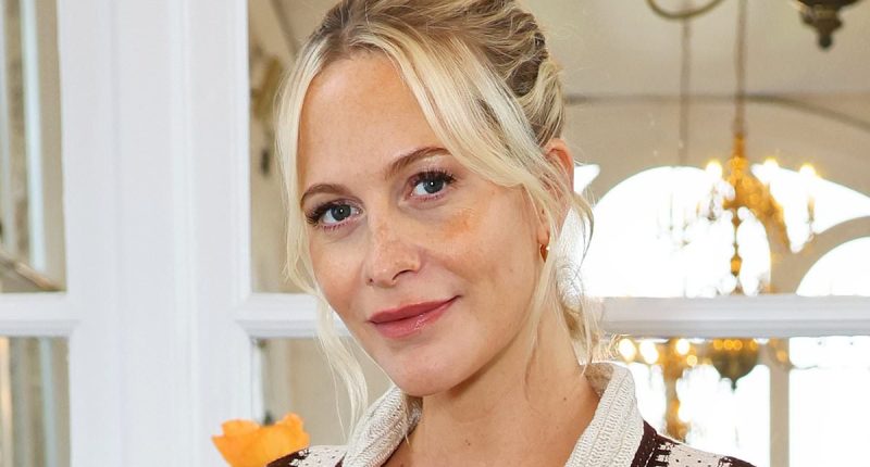 Pregnant Poppy Delevingne cradles her baby bump in a trendy striped shirt co-ord as she celebrates her new collaboration with Nobody's Child