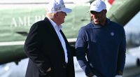 US President Donald Trump walks with Saquon Barkley