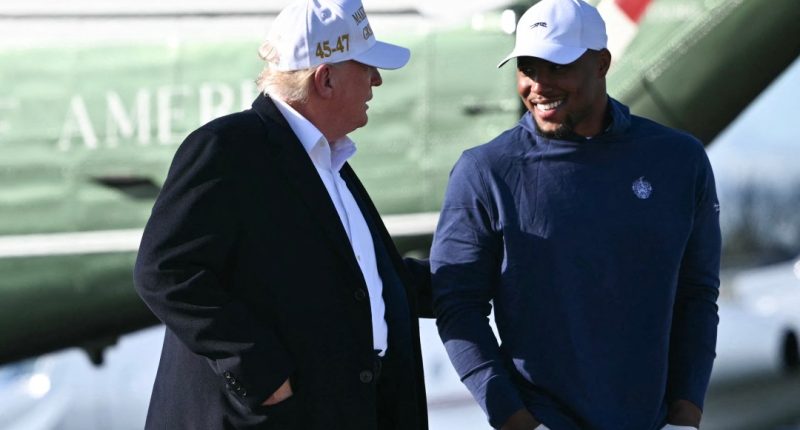 US President Donald Trump walks with Saquon Barkley