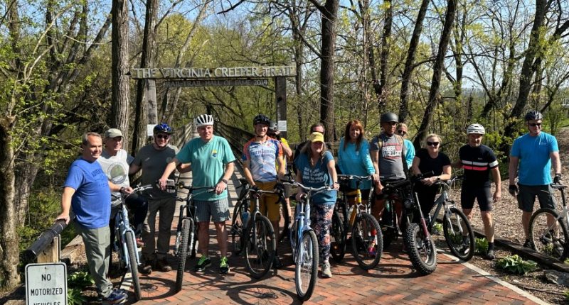 Sen. Mark Warner, local leaders bike Creeper Trail as post-Helene recovery continues
