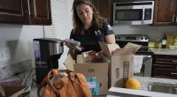 Shea Giagnorio packs belongings in her apartment days after getting fired from her job with the Administration for Children and Families, Monday, April 14, 2025, in Overland Park, Kan. (AP Photo/Charlie Riedel)