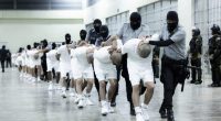 In this photo provided by El Salvador's presidential press office, prison guards transfer deportees from the U.S., alleged to be Venezuelan gang members, to the Terrorism Confinement Center in Tecoluca, El Salvador, March 16, 2025. (El Salvador presidential press office via AP, File)