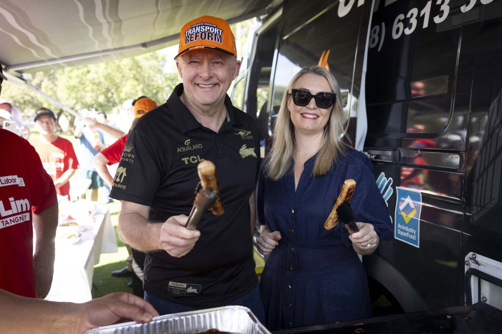 Prime Minister Anthony Albanese with partner Jodie Haydon with some sausages in Perth.