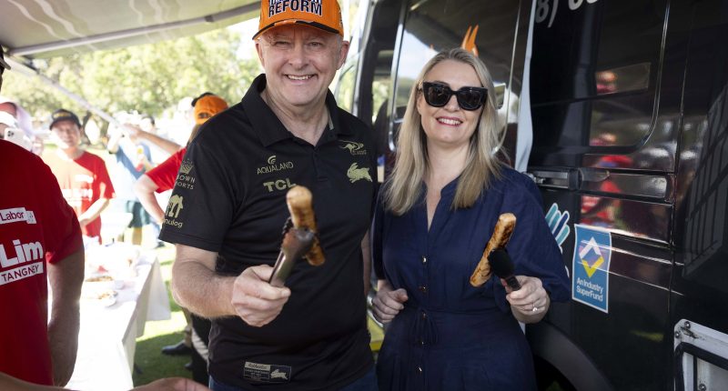 Prime Minister Anthony Albanese with partner Jodie Haydon with some sausages in Perth.