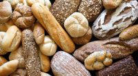 Overhead shot of many assorted breads and rolls.