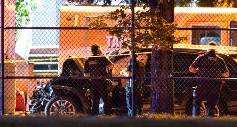Police officers investigating a car accident.