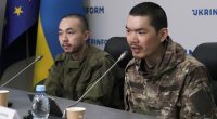 Two Chinese nationals captured by Ukrainian soldiers at a press conference in Kyiv.