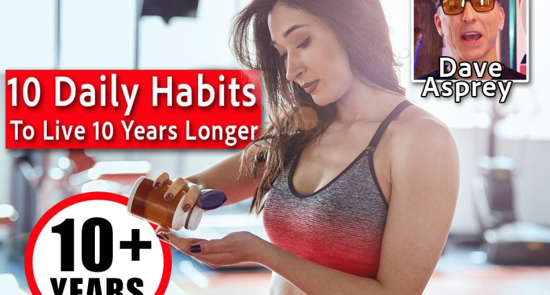 A fit sportswoman standing in a gym and taking pre workout pills.