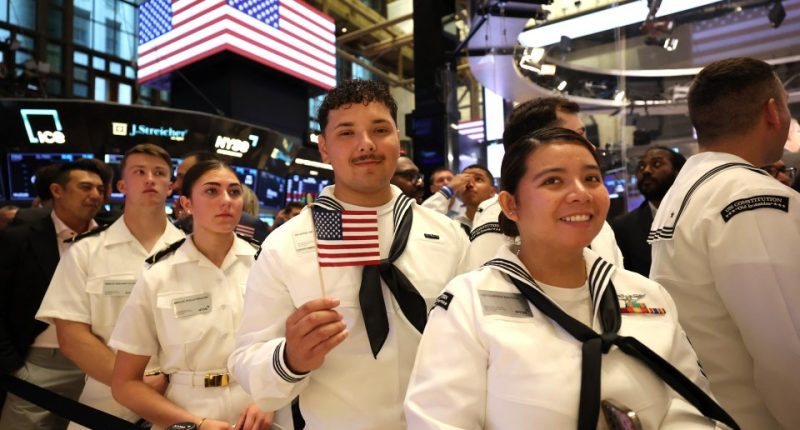 Military personnel at the New York Stock Exchange.