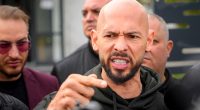 Andrew Tate speaking to the media outside a police station.