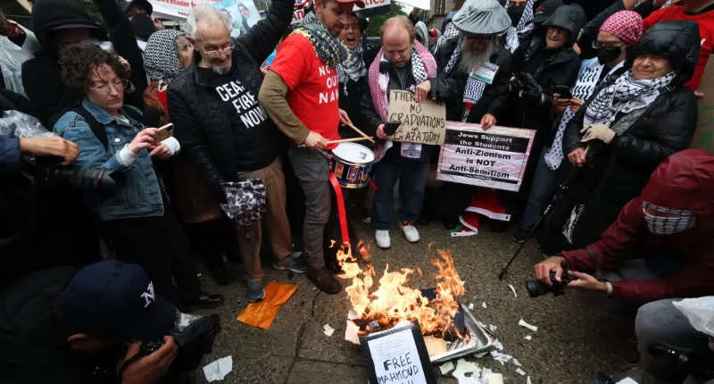 Anti-Israel protesters torch diplomas outside Columbia University on graduation day