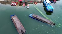 Aerial view of a search and rescue operation at a capsized boat accident site.