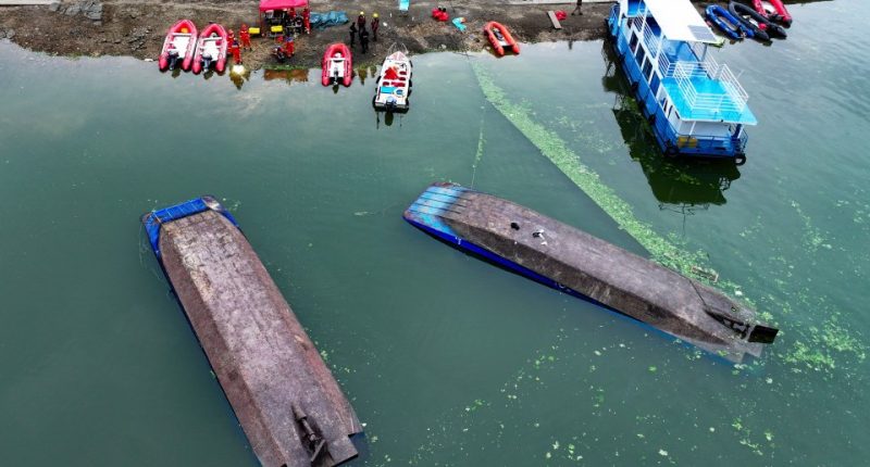 Aerial view of a search and rescue operation at a capsized boat accident site.