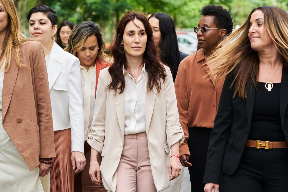 A group of women walking outside a courthouse.