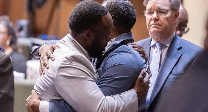 Cops hug and cry as they're CLEARED in death that shocked America