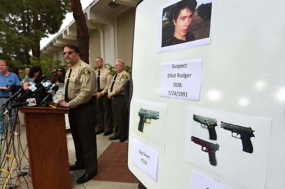 Photo of a press conference where law enforcement officials display photos of Elliot Rodger and the weapons used in the Isla Vista shooting.