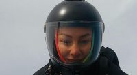 Person wearing a helmet with a camera mounted on top.