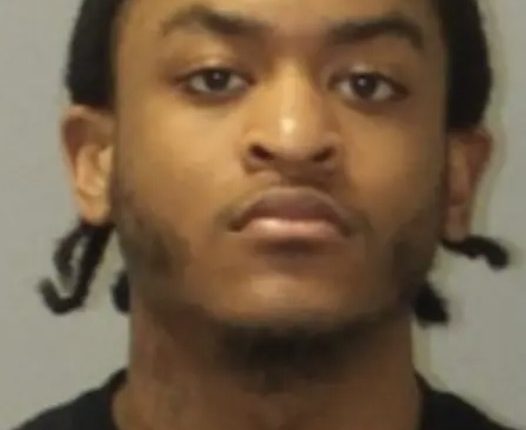 Mugshot of a young man with dark hair.