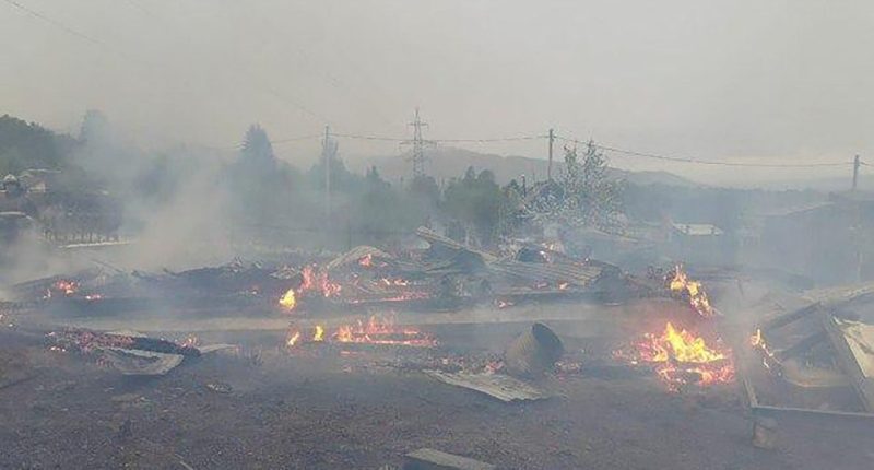 Burned-out remains of a house after a fire.