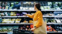 Woman shopping for produce in a supermarket.
