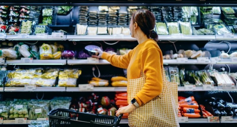 Woman shopping for produce in a supermarket.