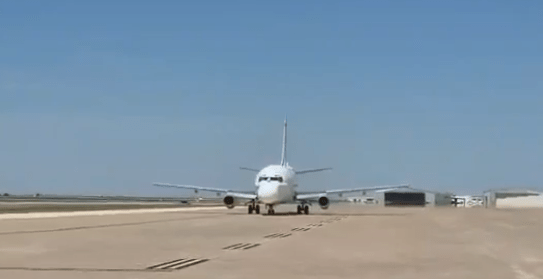 Airplane taxiing on a runway.