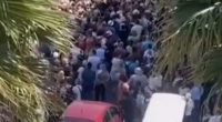 Large crowd of tourists overwhelming a narrow street in Sirmione.