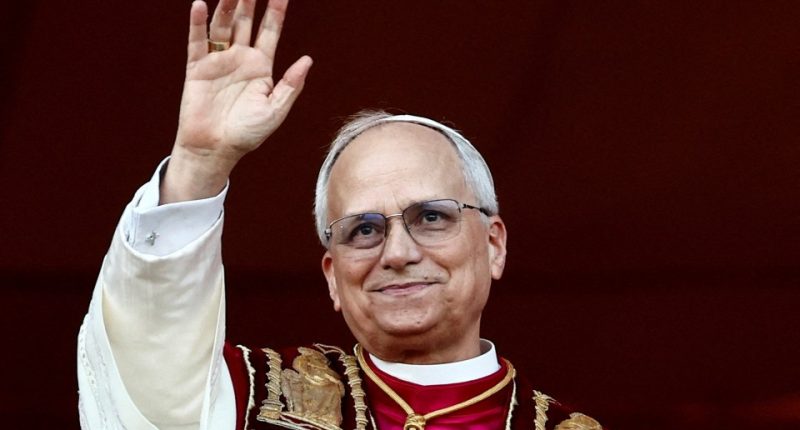 Pope Leo XIV waving from a balcony.