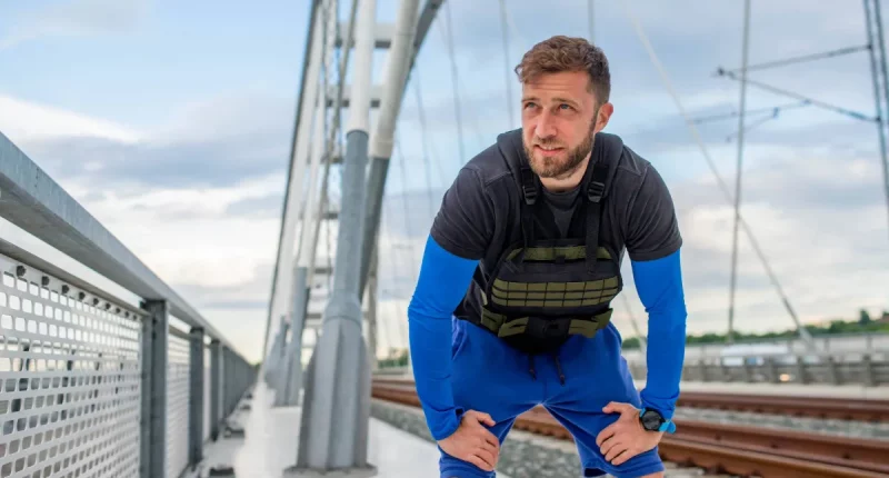 man getting tired during walk with weighted vest