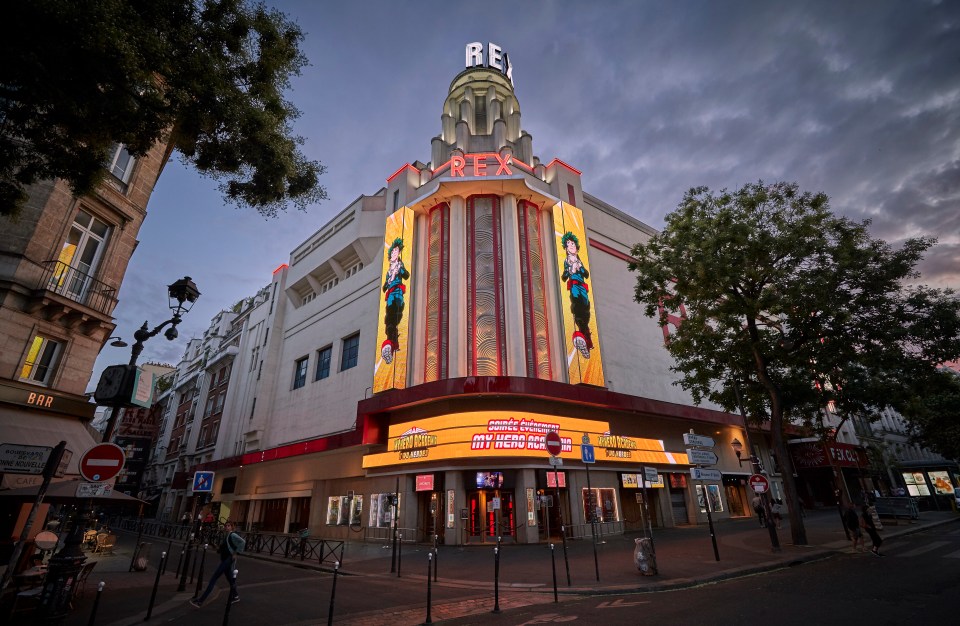 The Grand Rex cinema in Paris at dusk, showing a My Hero Academia movie poster.