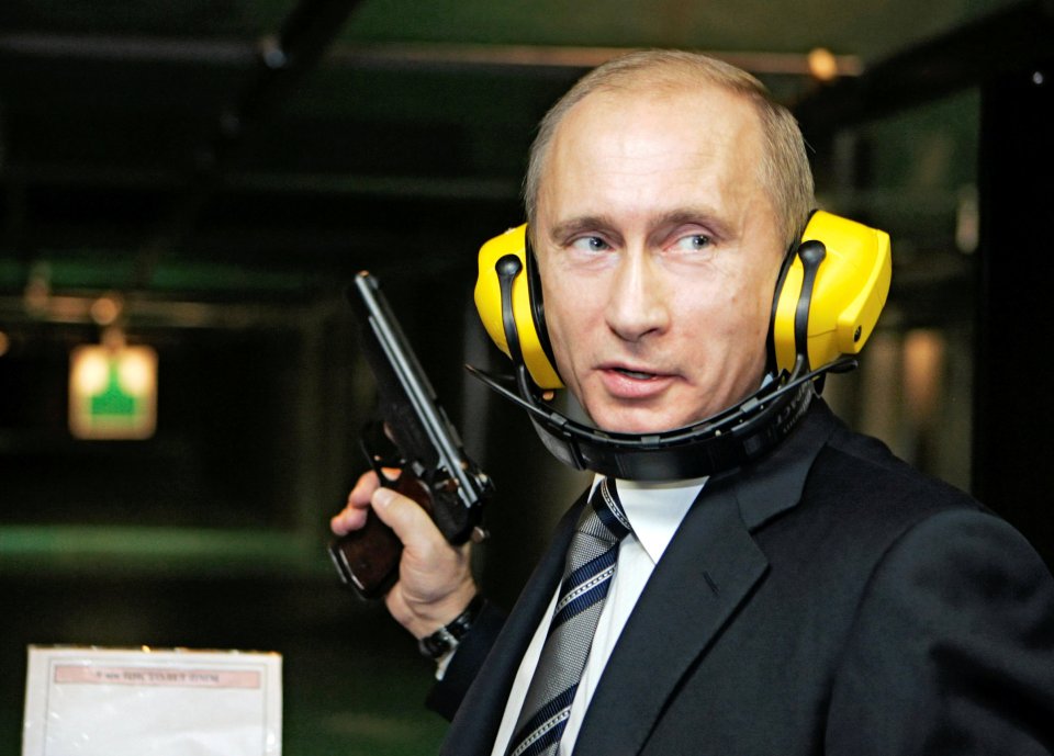 Vladimir Putin at a shooting range, holding a handgun.