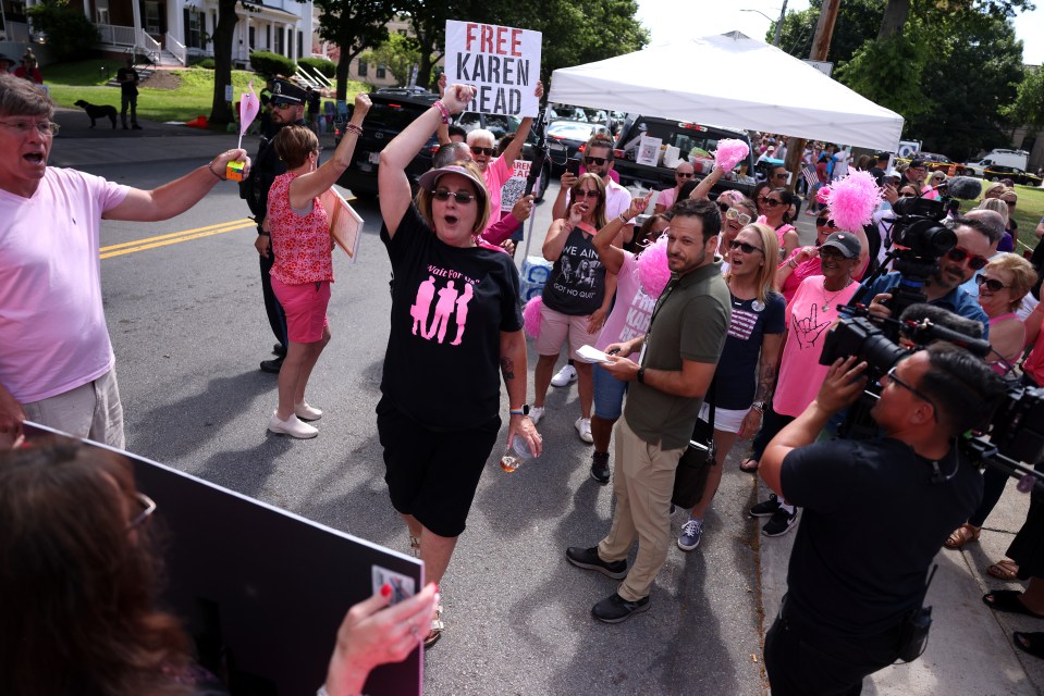 Supporters holding signs and cheering for Karen Read outside a courthouse.