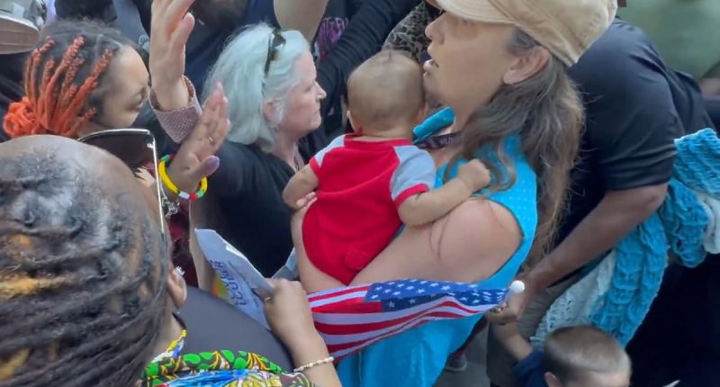 Moment trans mob surrounds Christian mother and her baby