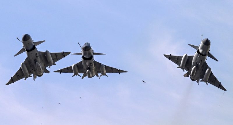 Three Pakistan Air Force J-10 fighter jets in flight.