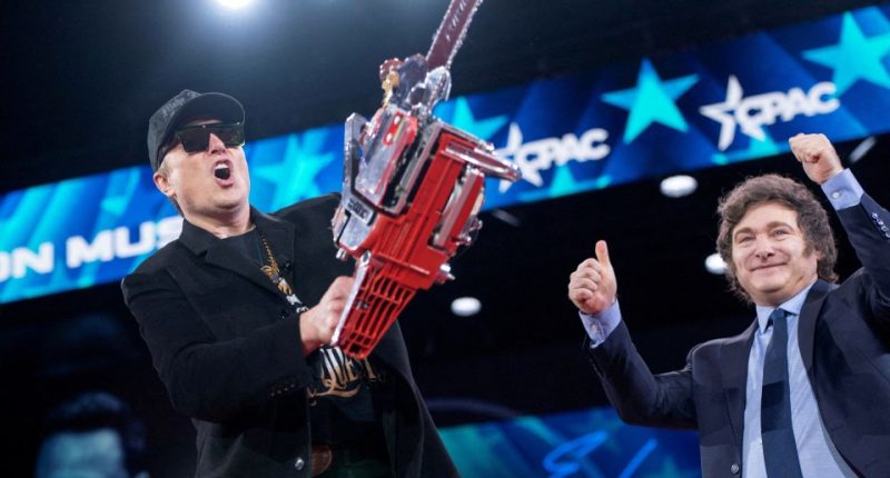 Elon Musk holding a chainsaw given to him by Javier Milei at CPAC.